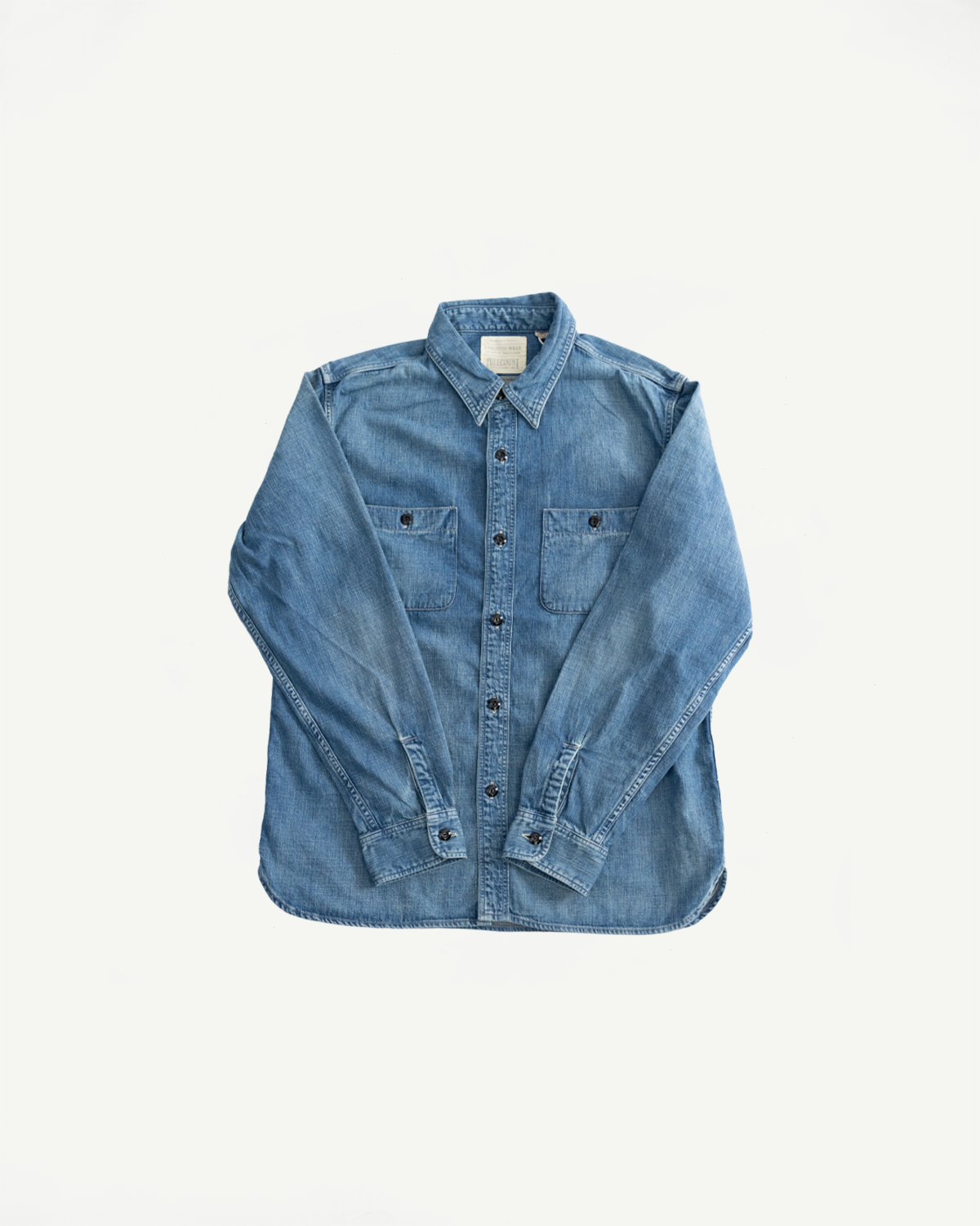 Flat lay of denim work shirt, front view, showing chest pockets, button front, and collar details.