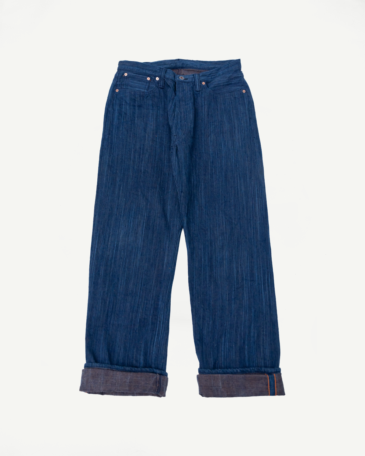 Front view flat lay of Graph Zero 13oz aizome persimmon dyed selvedge jeans, straight fit, cuffed hem, visible texture.