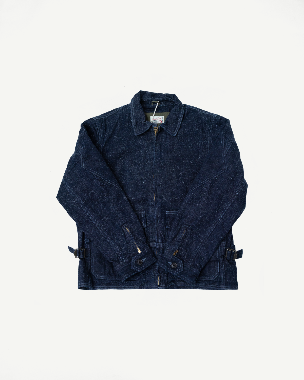 Front view of dark selvedge denim work jacket with button collar, zip closure, and flap pockets