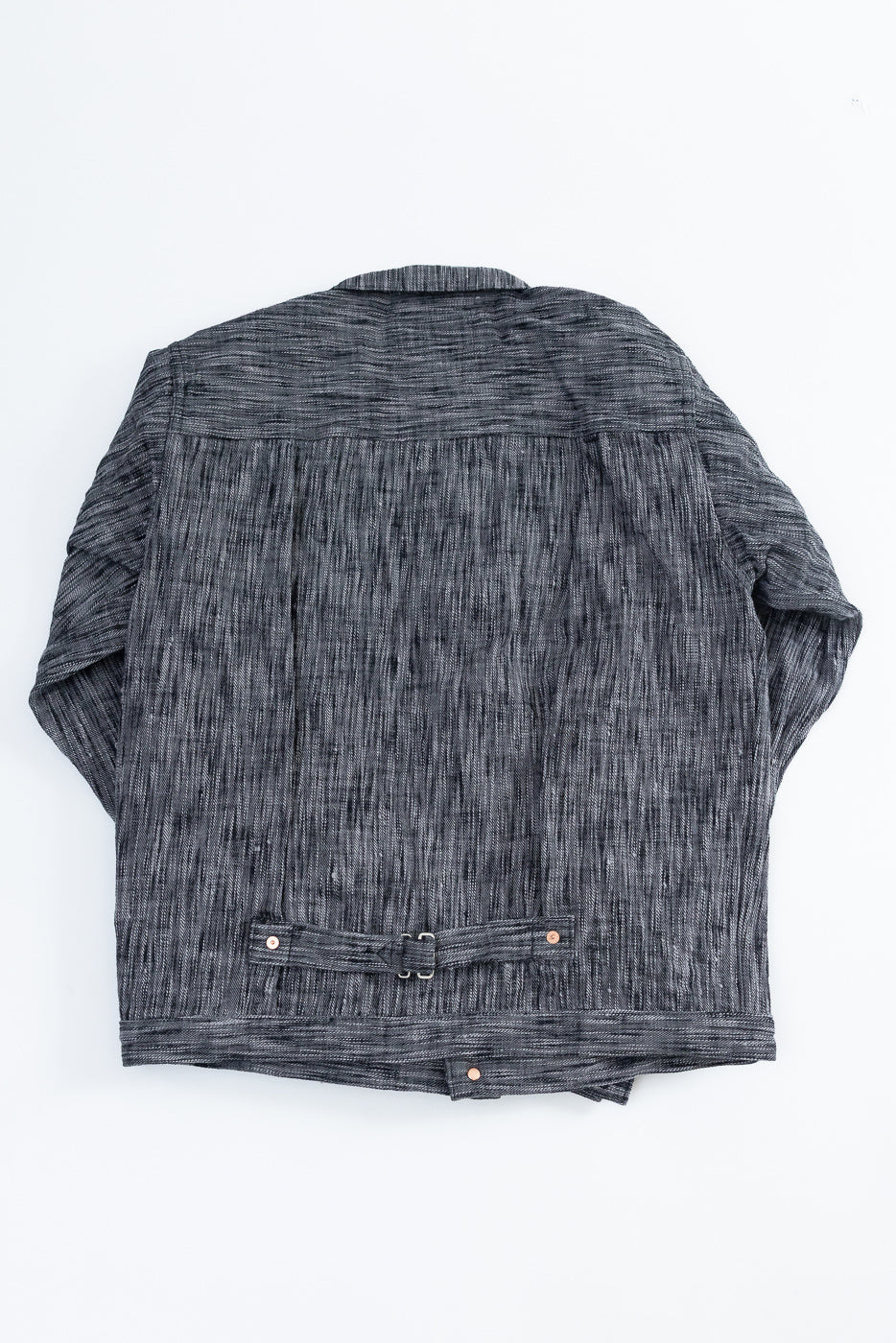 Back view of dark gray textured shirt with belt detail and copper buttons, flat lay