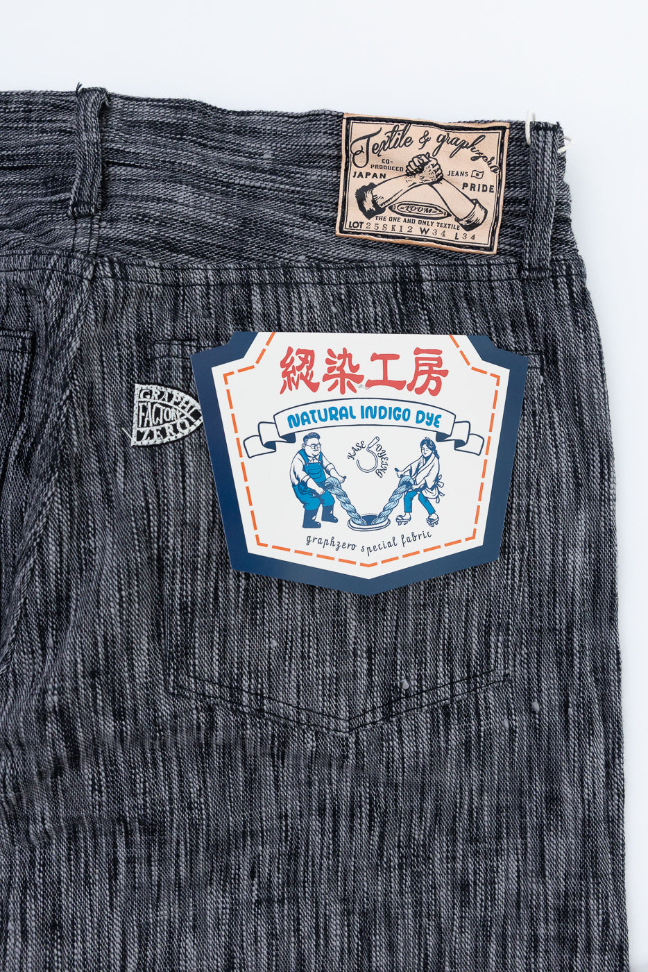 Close-up of back pocket with natural indigo dye tag, selvedge denim fabric, and Japanese textile label details