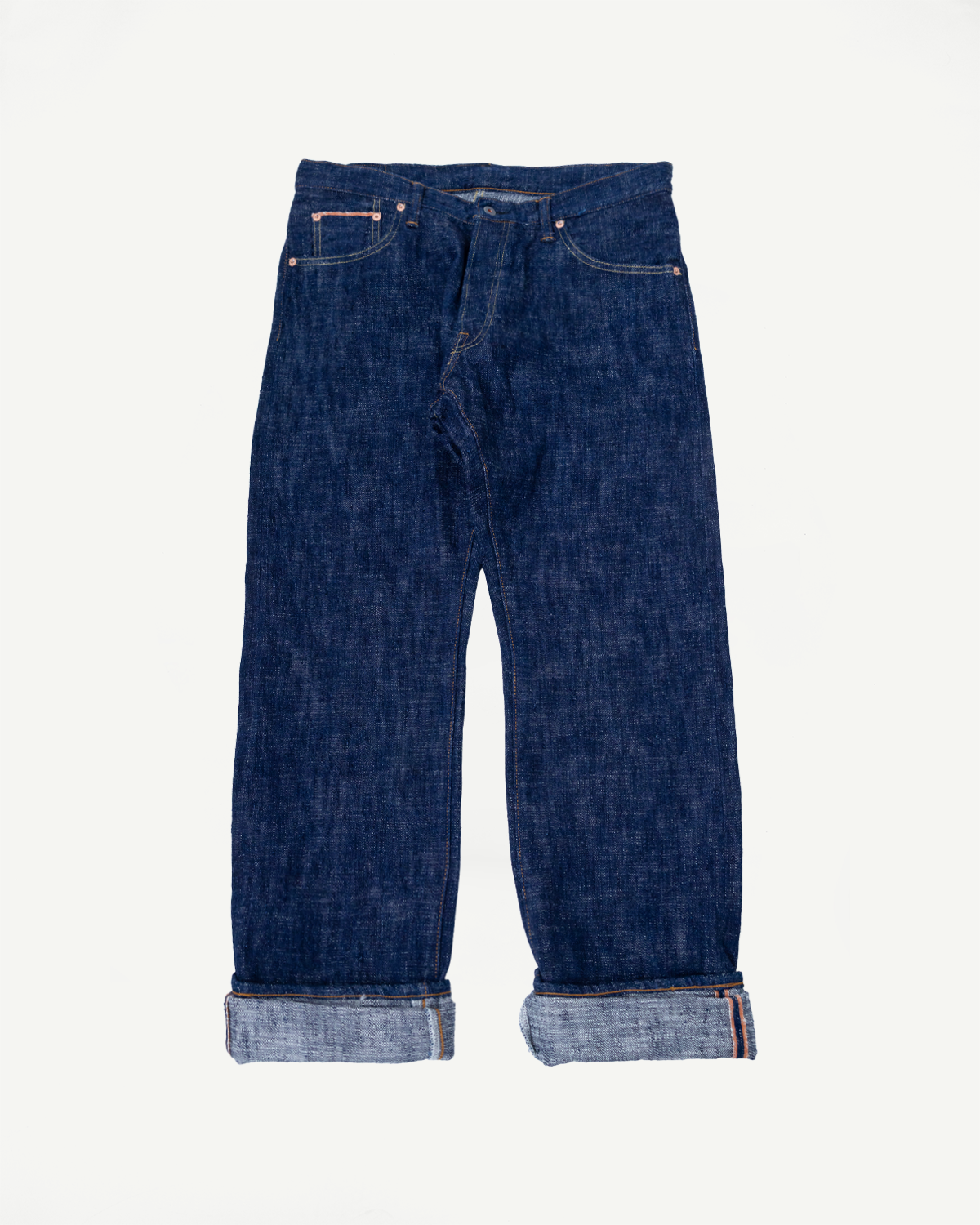 Flat lay, front view of Graph Zero 15oz slubby blue indigo selvedge jeans with cuffed hems.
