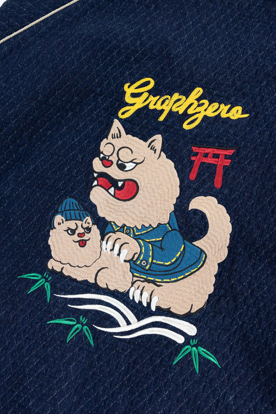 Close-up of embroidered cat design on denim, front view, featuring 'Graphzero' text and bamboo details.