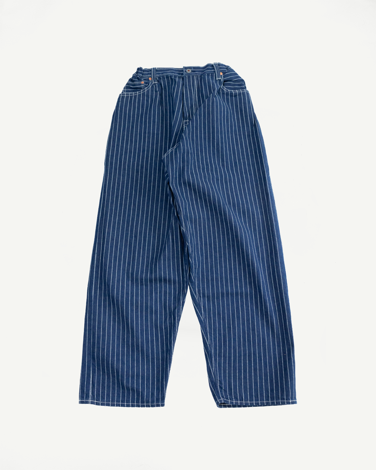 Front view of blue striped selvedge pants, wide-leg design, visible stitching and button details