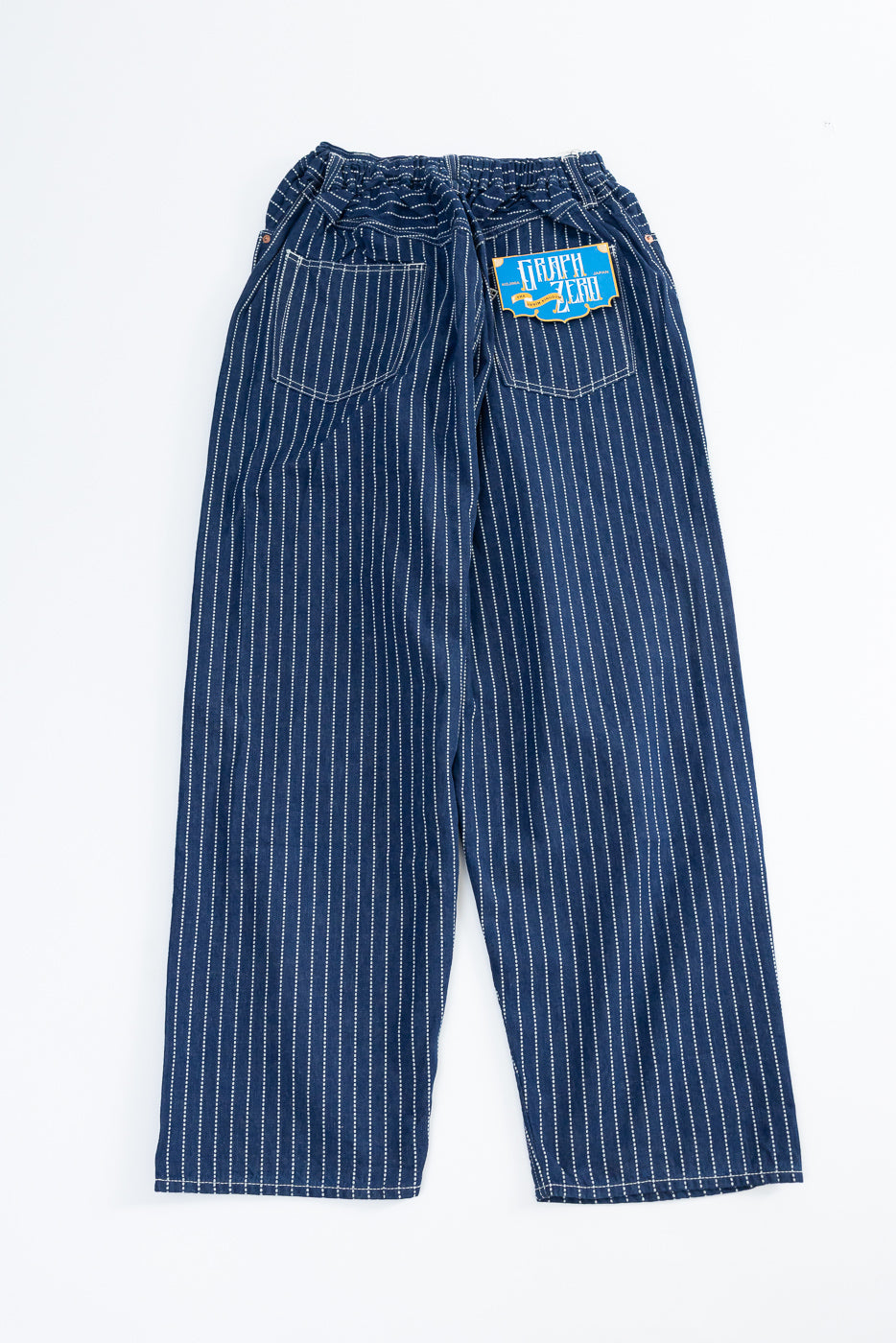 Back view of navy pinstripe pants with elastic waist, rear pockets, and 'Graph Zero' patch detail.