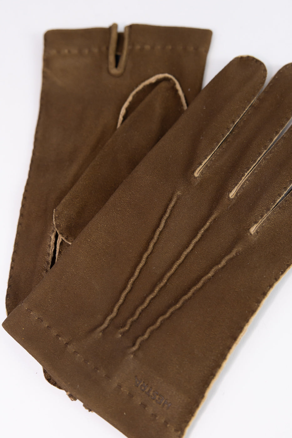 Close-up of Hestra Damien loden brown leather gloves, front side, showing stitching details.