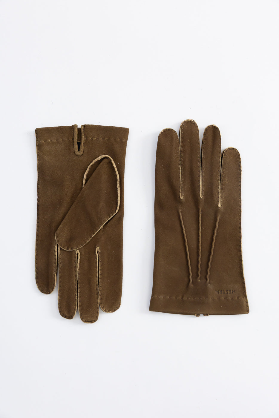 Flat lay of Hestra Damien loden brown suede gloves, front and palm sides, visible stitch details.