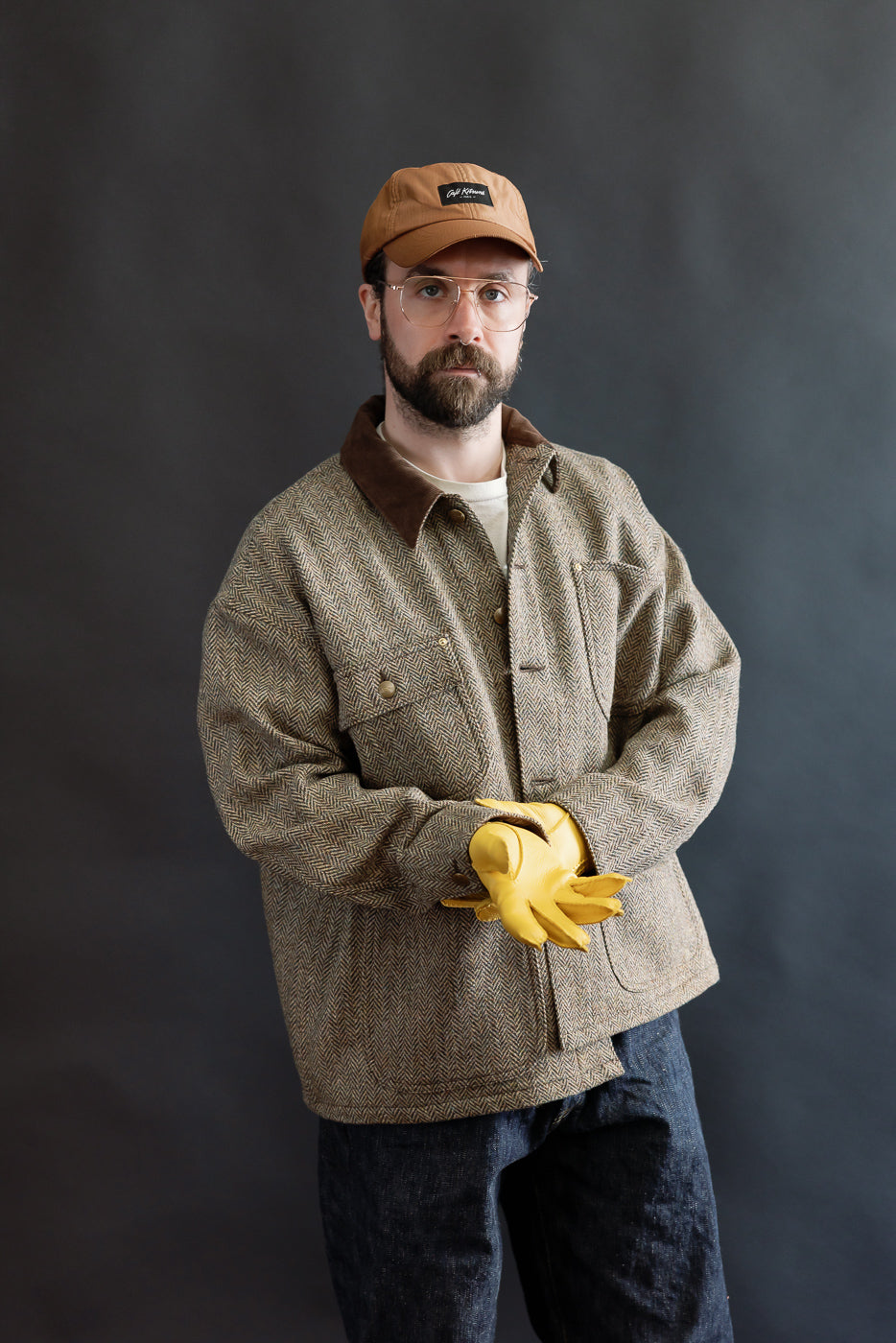 Front close-up of Hestra Henry natural yellow gloves, worn by male model 5'9