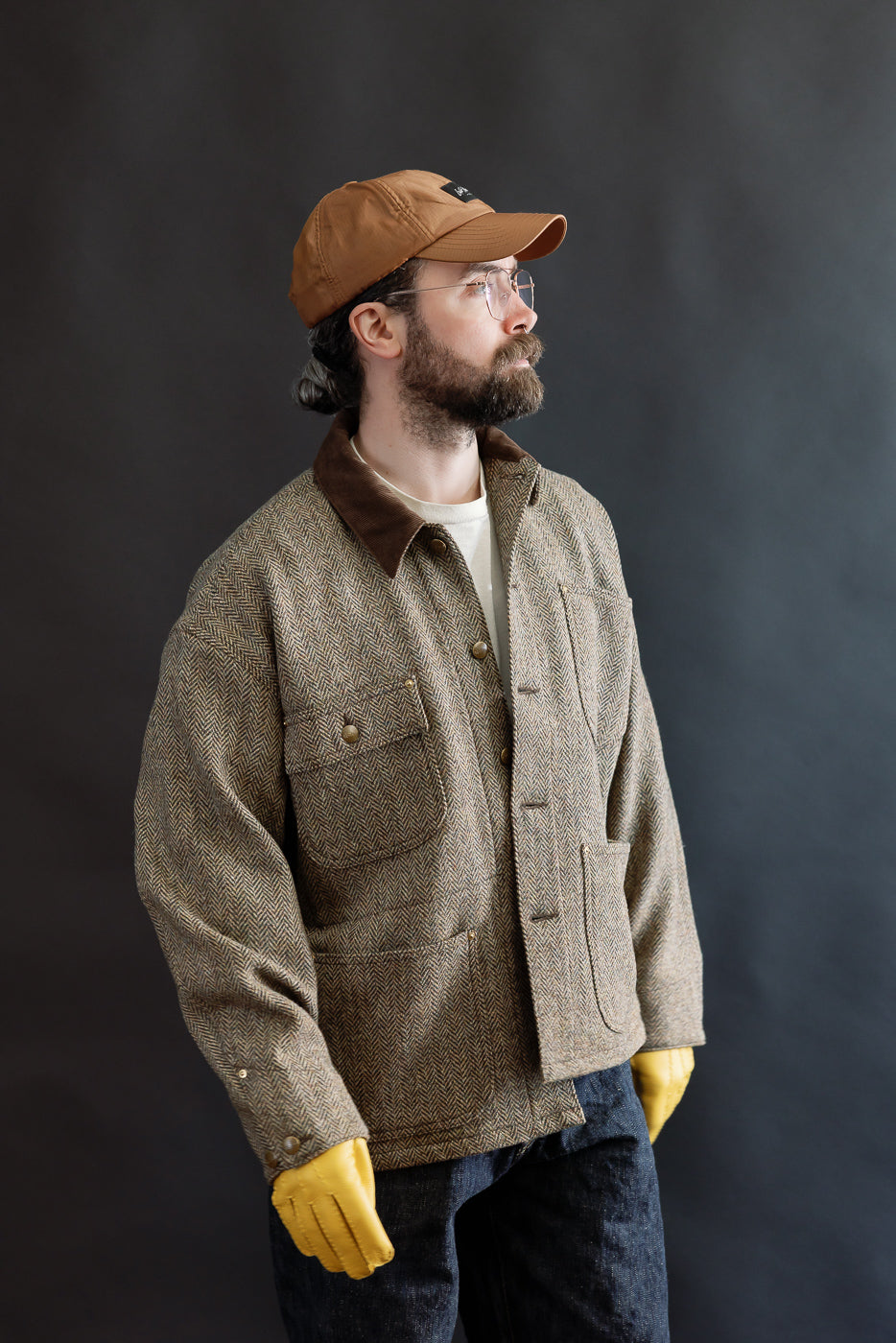 Close-up of natural yellow Hestra Henry glove on male model, front view, casual outfit accessory