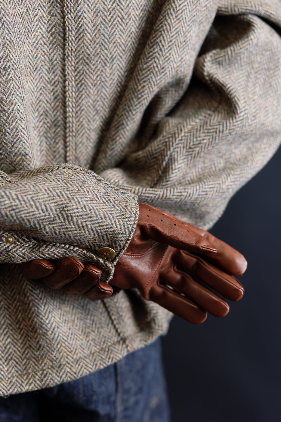 Close-up of Hestra Morgan chestnut brown leather driving glove on male model, 5'9