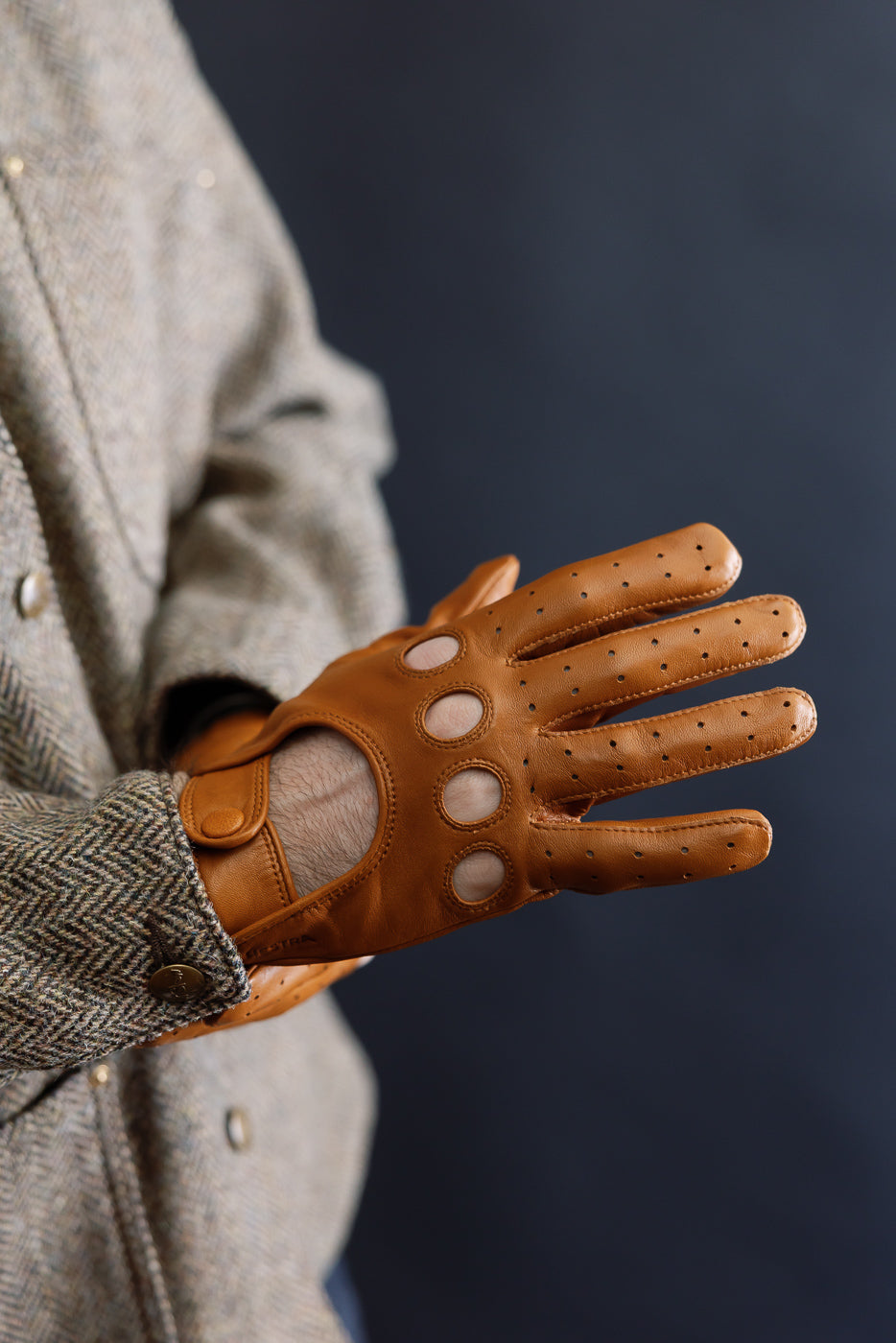 Close-up of men's Hestra Morgan cork driving glove, brown leather, model is male, 5'9