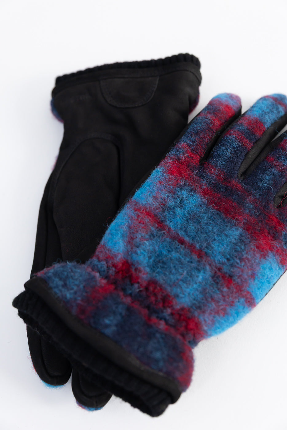 Close-up of Hestra Noah plaid wool gloves, navy blue and red, front and palm flat lay