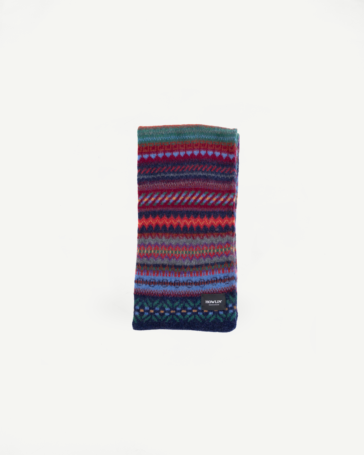 multicolored, patterned wool scarf with a navy base on a white background