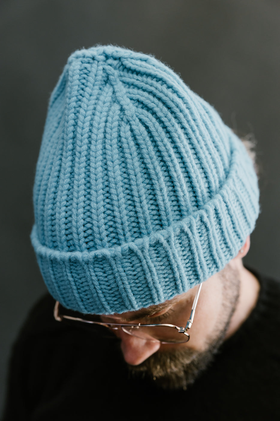 aquamarine ribbed chunky beanie, watch cap on a bearded man, close up