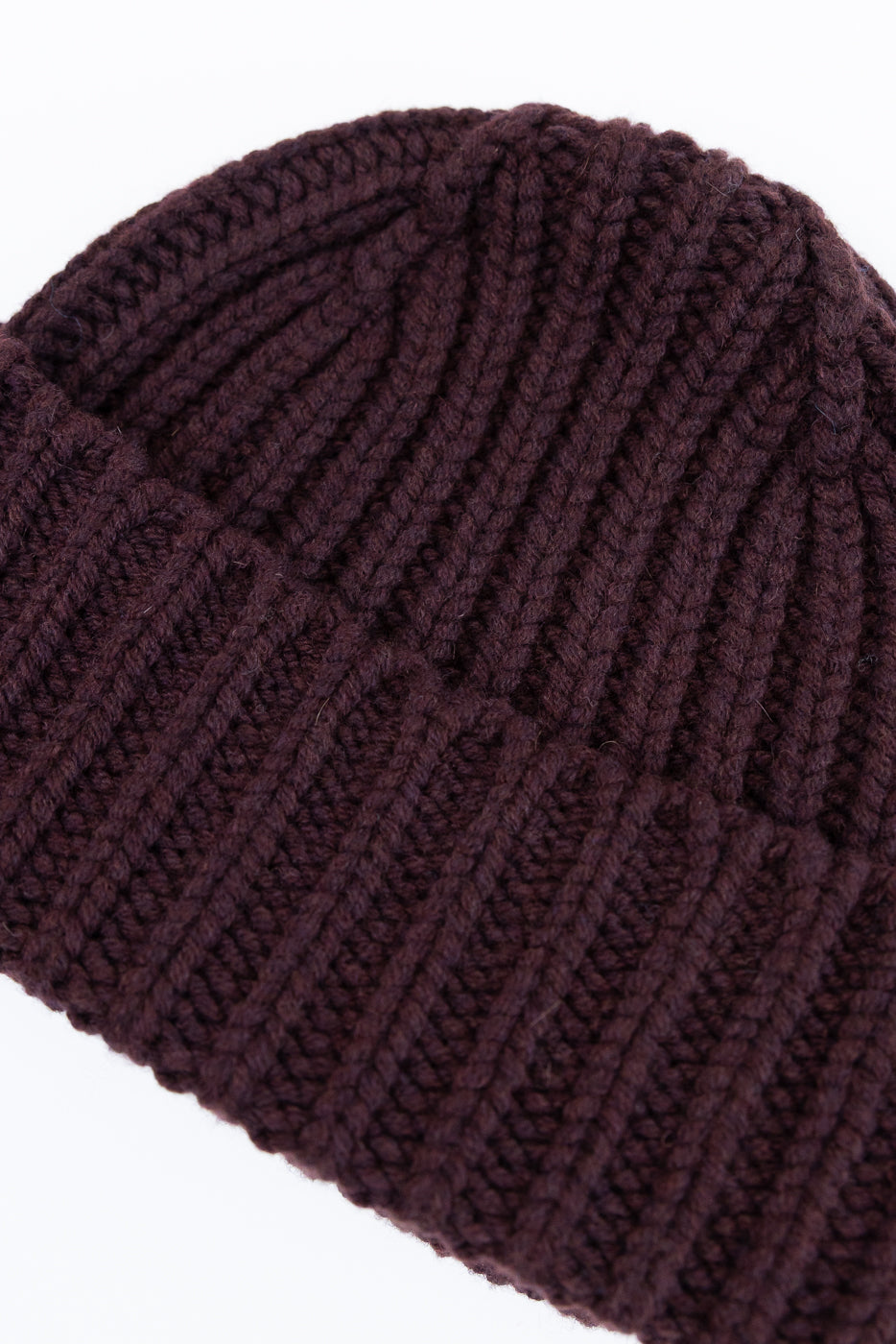Brown knit beanie on a light gray background