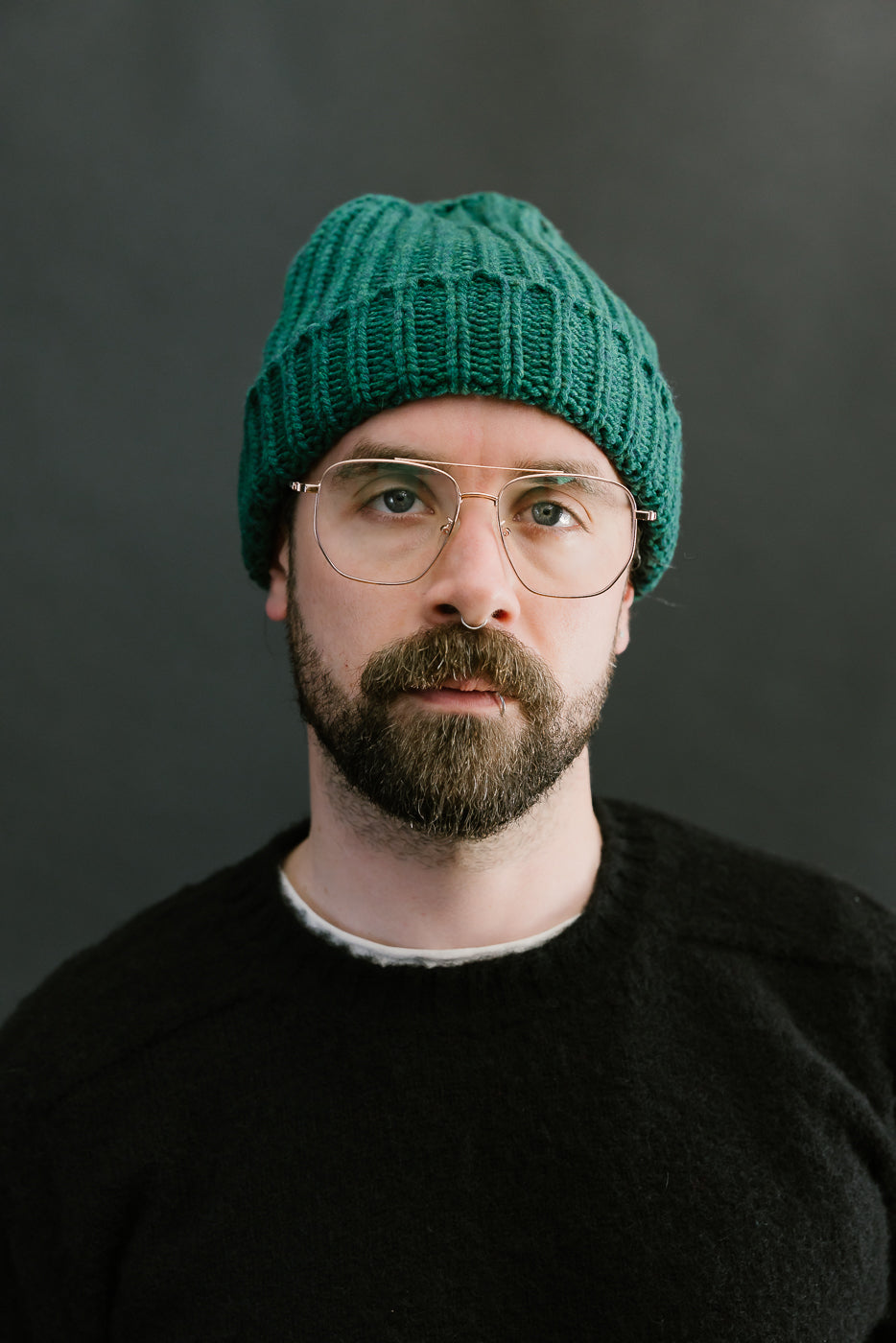 green mix ribbed chunky beanie, watch cap on bearded mans head, front view