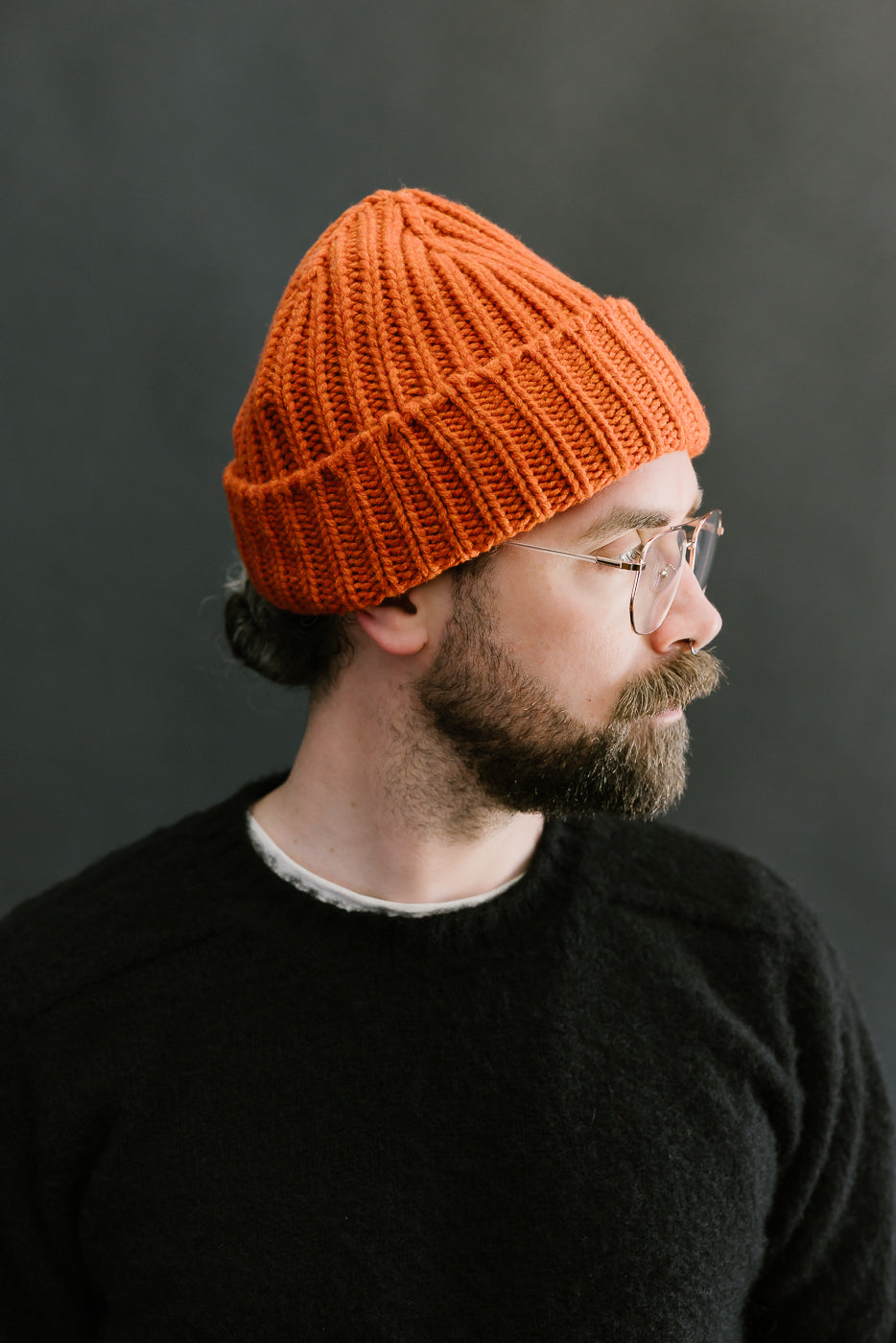 safety orange ribbed chunky beanie, watch cap on bearded mans head, side view