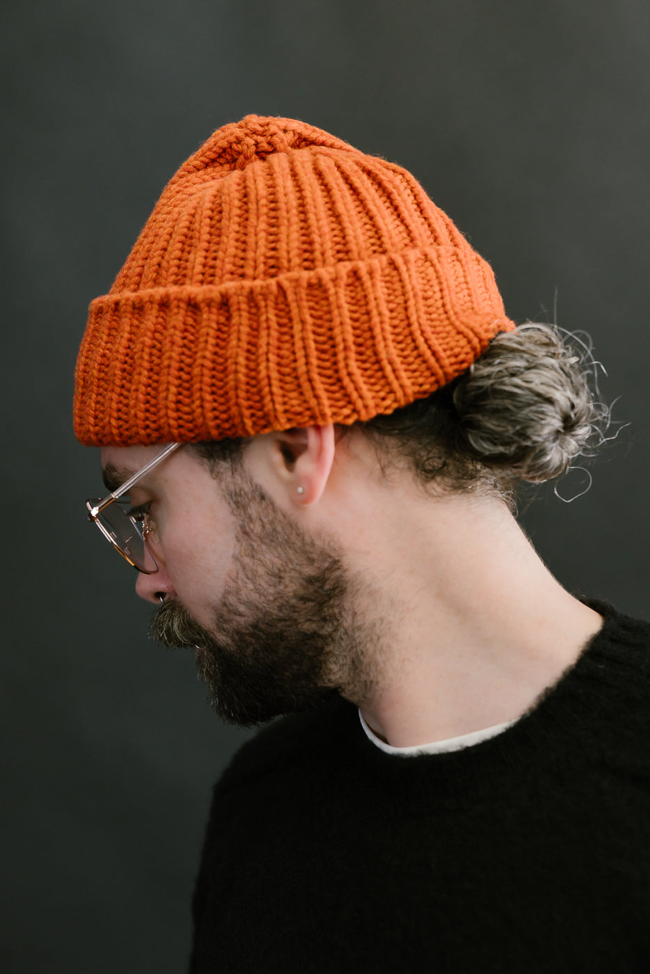safety orange ribbed chunky beanie, watch cap on bearded mans head, side view