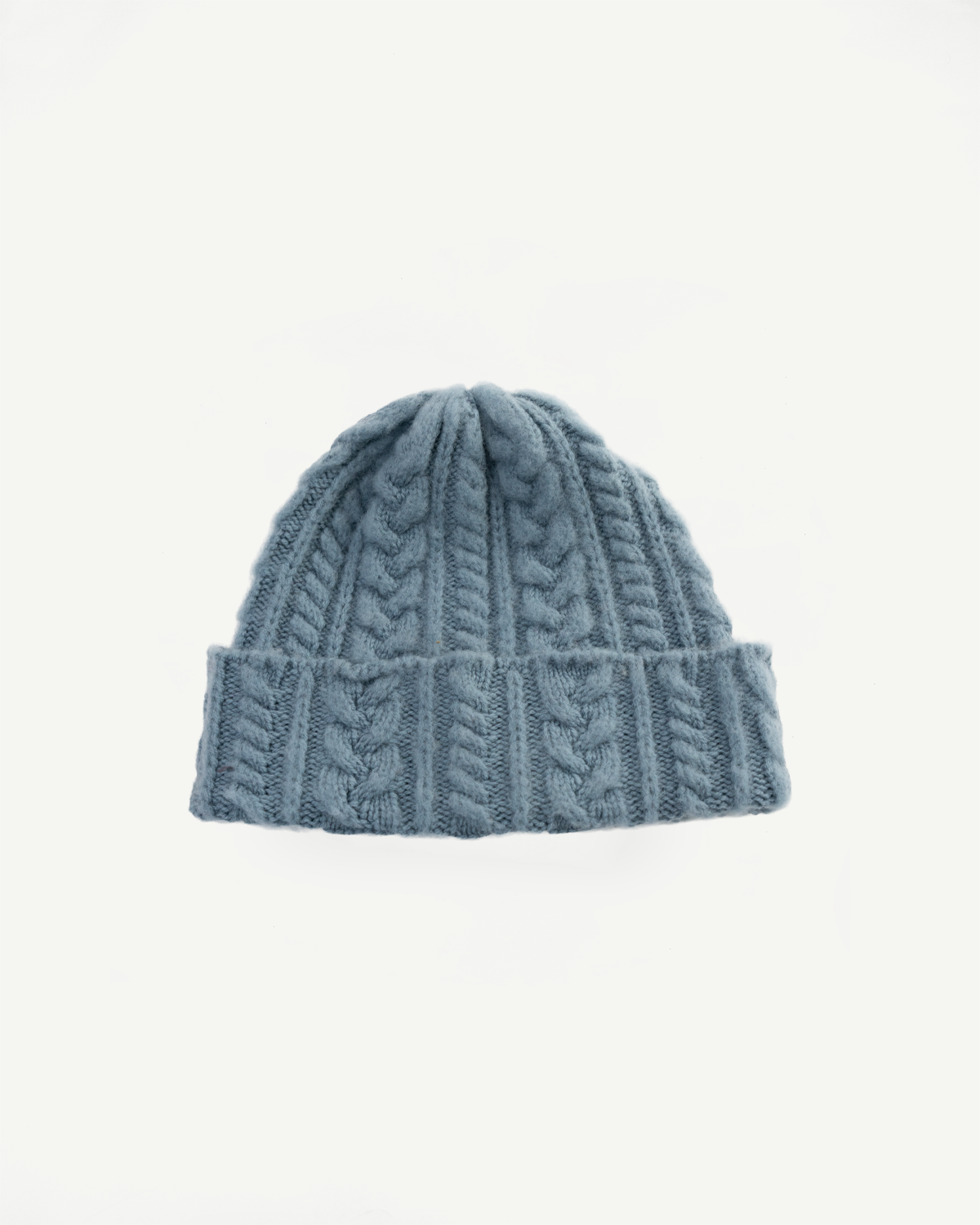 Soft blue cable knit beanie front flat lay, shows folded brim and textured knit pattern, Dant