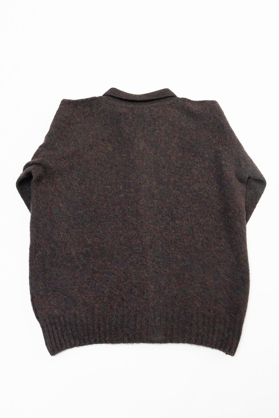 Flat lay of dark brown crewneck sweater, back view, ribbed hem, textured wool fabric