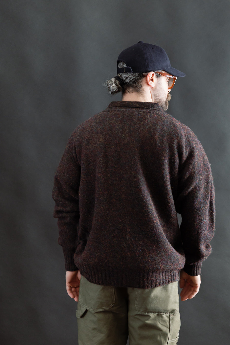 Back view of male model 5'9, 165lbs in athletic build wearing brown textured sweater, Dant casual apparel