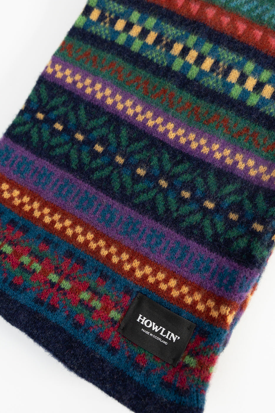 Close-up of Howlin' Future Is Mixed Up scarf front, colorful wool knit with label detail, Dant