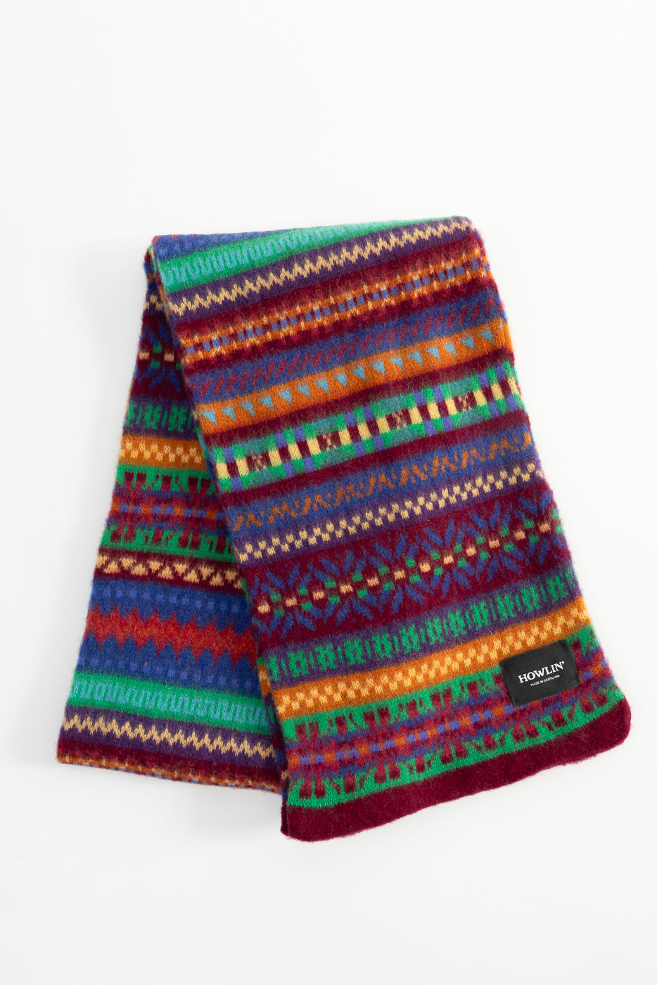 Flat lay front view of Howlin' Future Is Mixed Up Scarf, multicolor knit, visible brand tag.