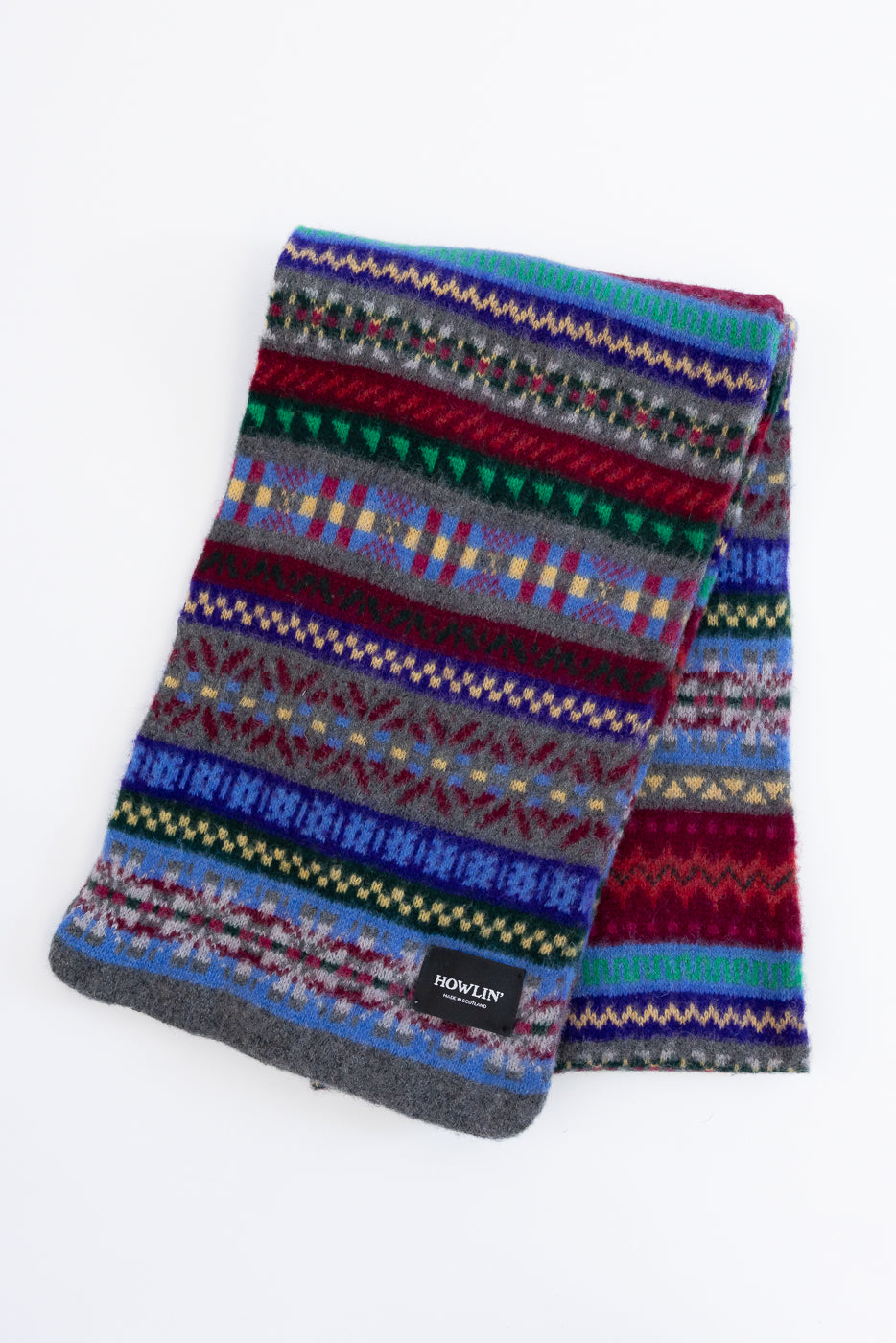 multicolored, patterned wool scarf with a heather grey base on a white background