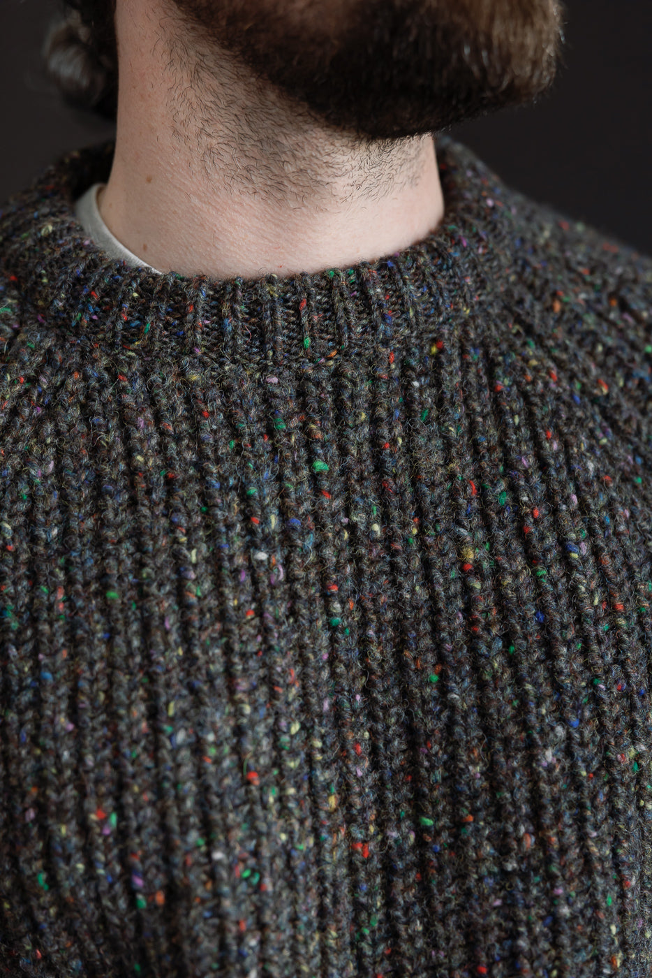 Close-up of front neck detail on men's speckled knit pullover, ribbed collar, Dant apparel