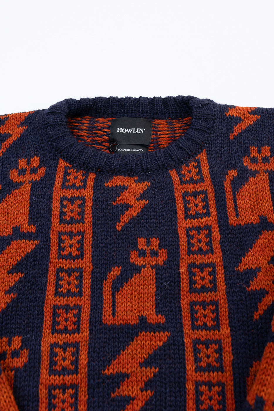 Close-up front of Howlin’ Thunder Cats Popover navy sweater, orange cat knit pattern, crewneck, fabric texture detail.