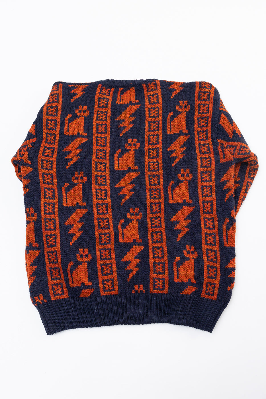 Flat lay of front side Howlin' Thunder Cats Popover navy sweater with orange cat and lightning pattern, ribbed hem, contemporary casual apparel from Dant.