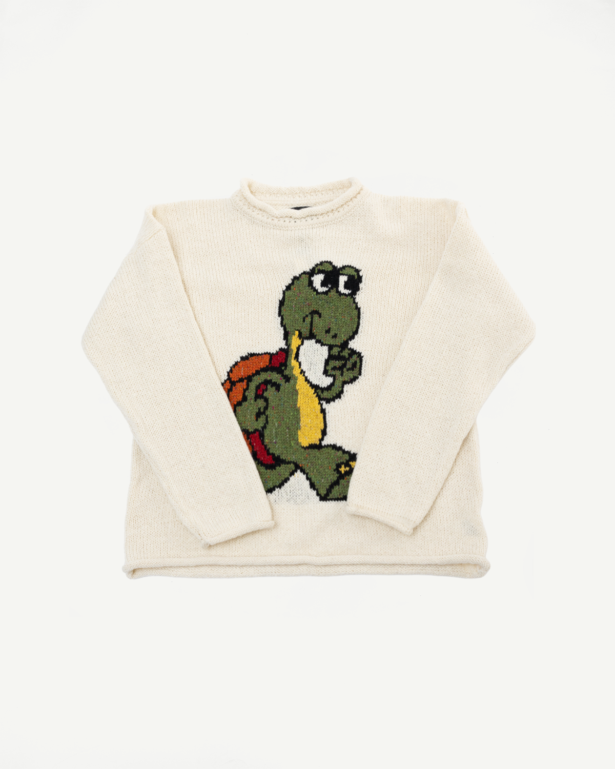 Flat lay front view of ecru knit sweater with cartoon turtle graphic, crewneck and long sleeves.