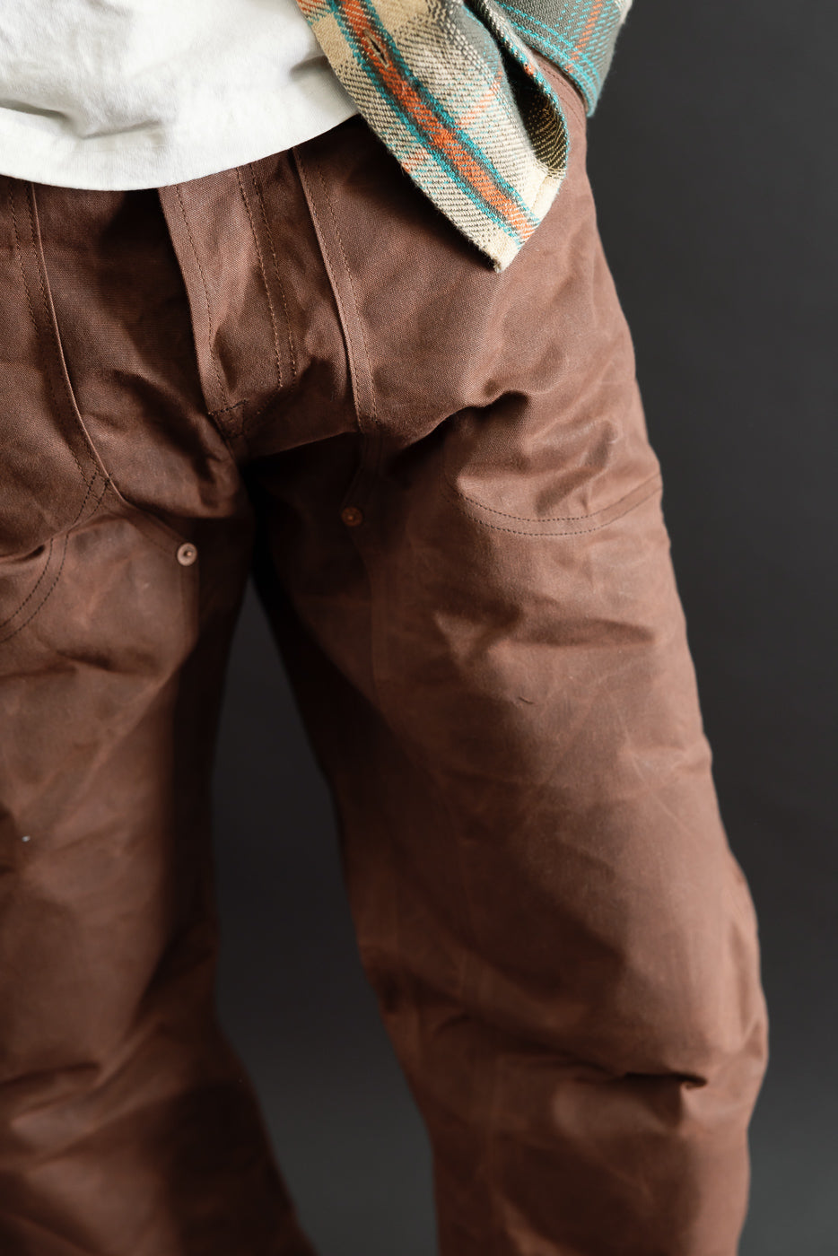Close-up front view of brown canvas work pants worn by a 5'9