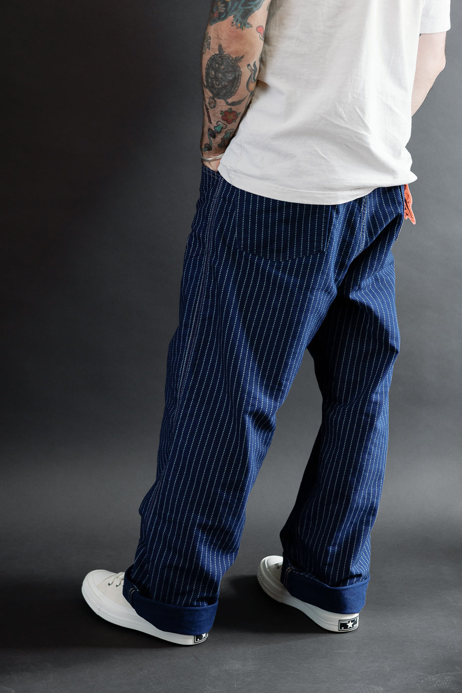 Back view of navy pinstripe pants on a 5'9