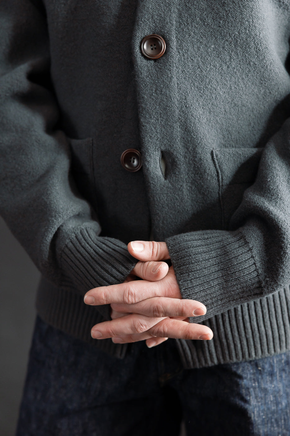 Close-up of front midsection of Indigofera Brewster dark grey boiled wool shirt on male model, 5'9