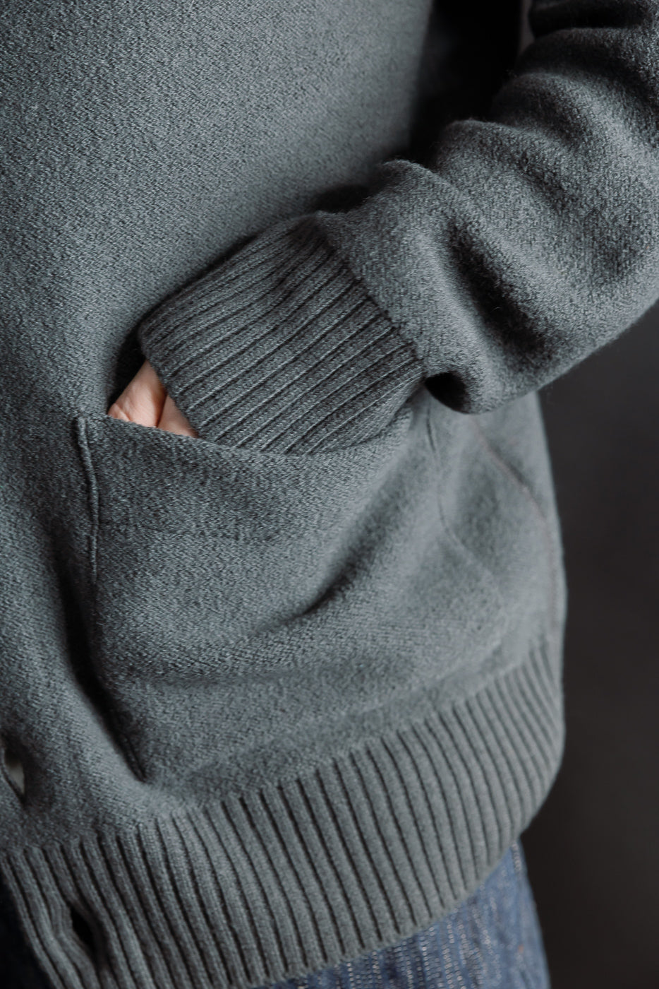 Close-up of male model's right side pocket and sleeve, Indigofera Brewster boiled wool shirt, dark grey