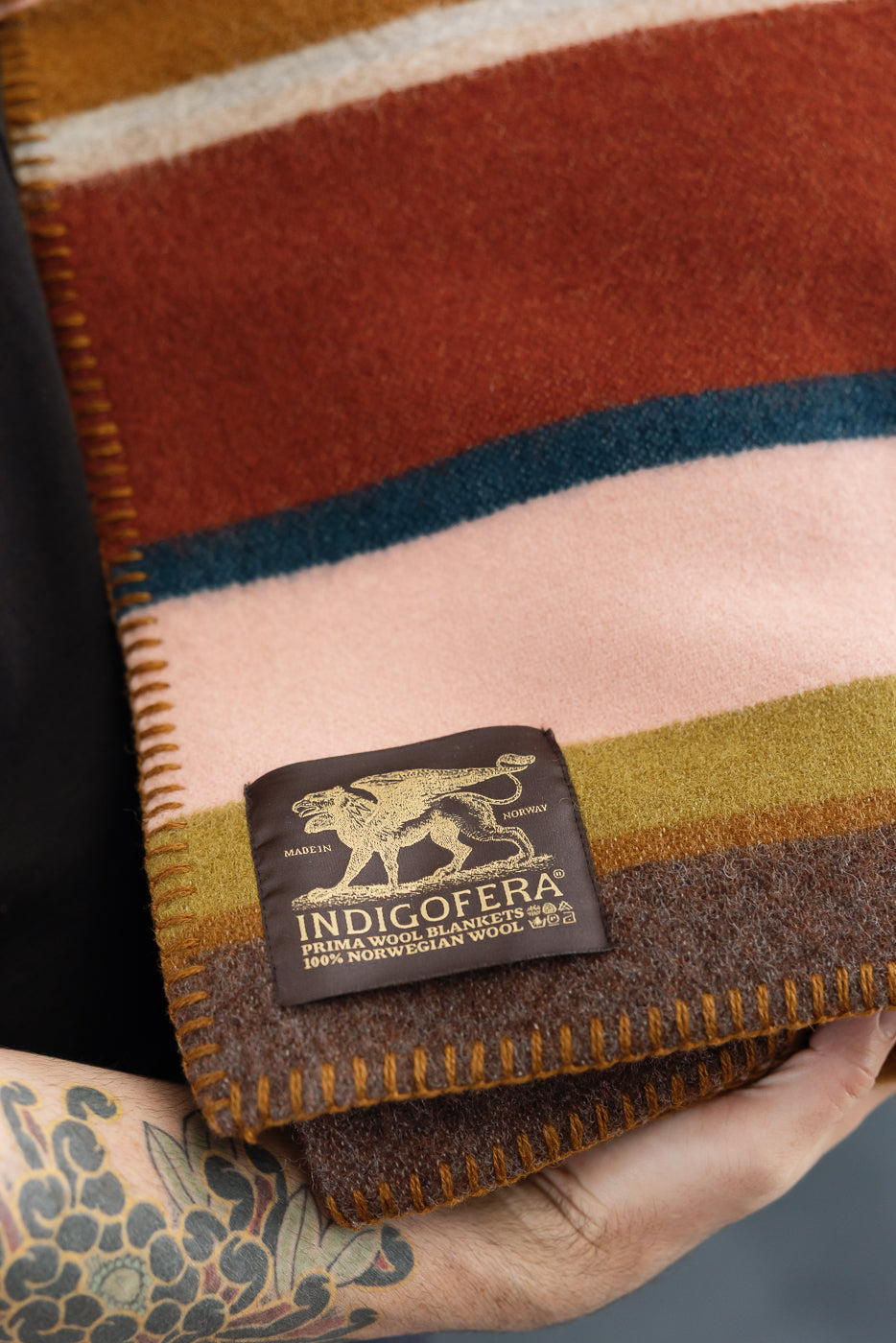 close up of the blanket, whip stitch, and indigofera logo