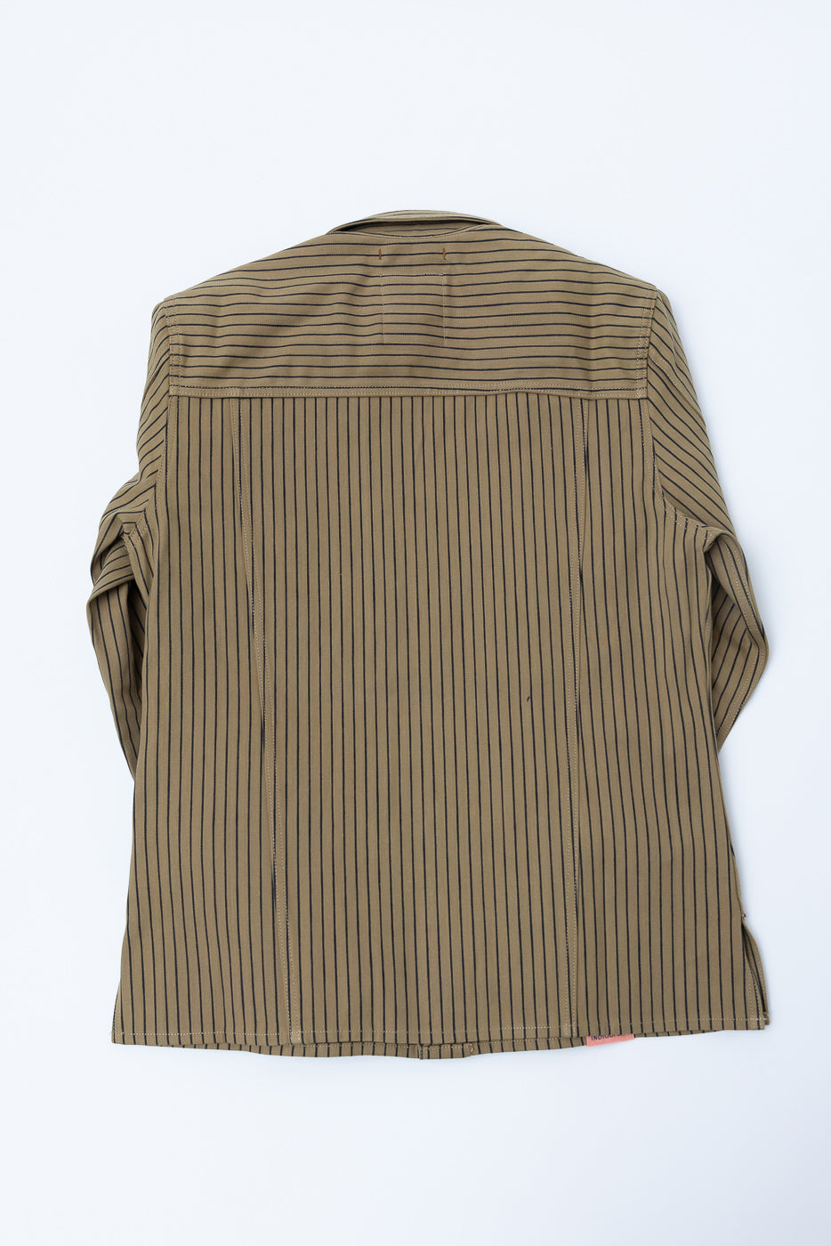 Flat lay showing the back of a beige and indigo striped shirt jacket, full view, no model
