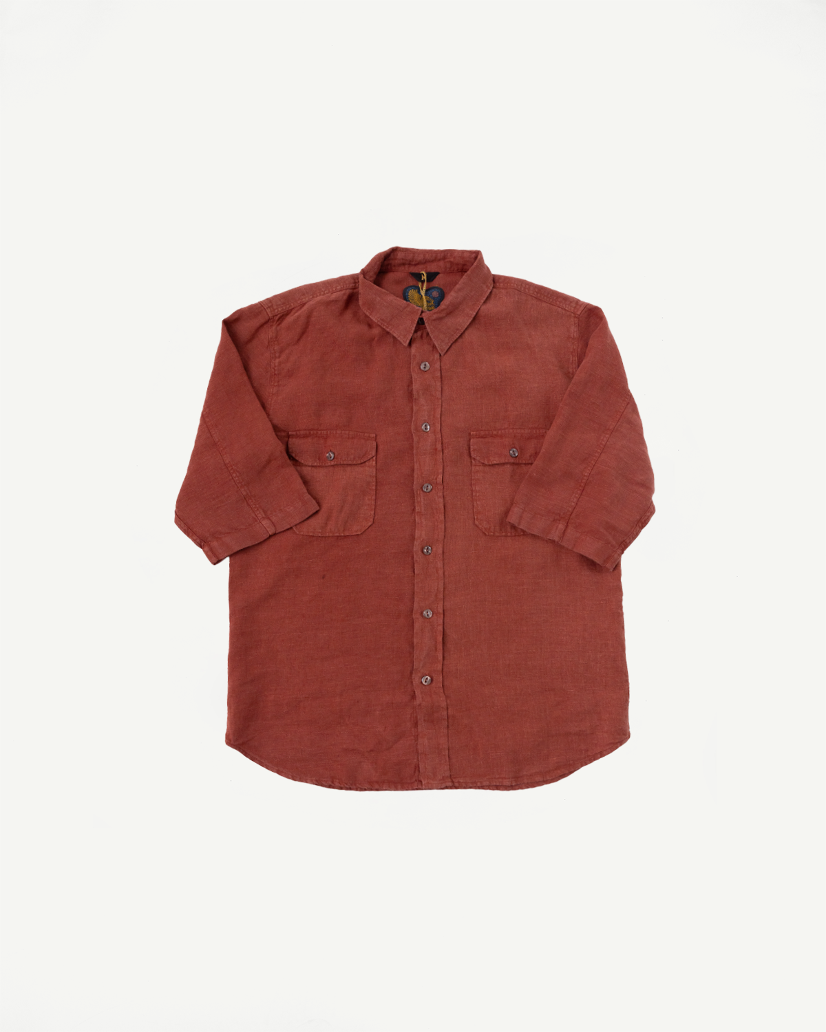 Rust-colored button-up shirt front view, featuring chest pockets and collar detail