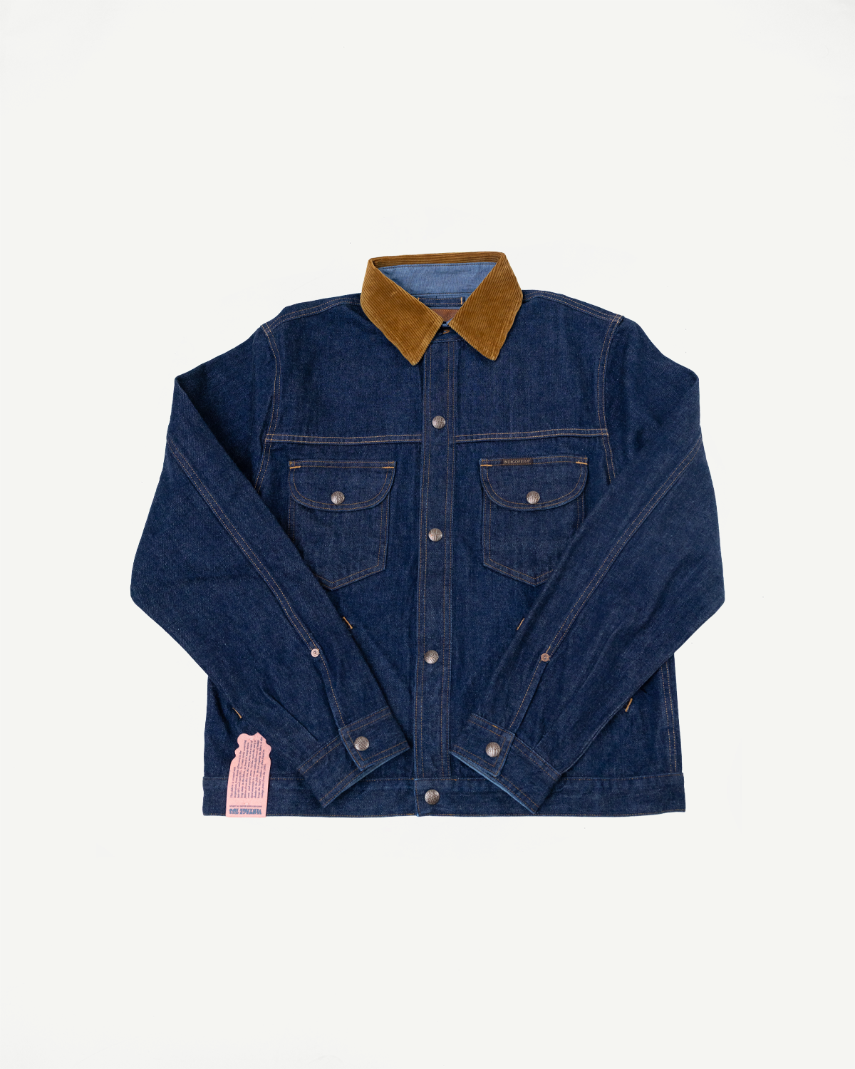 Front view of denim jacket with corduroy collar, button closures, and chest pockets on flat lay.