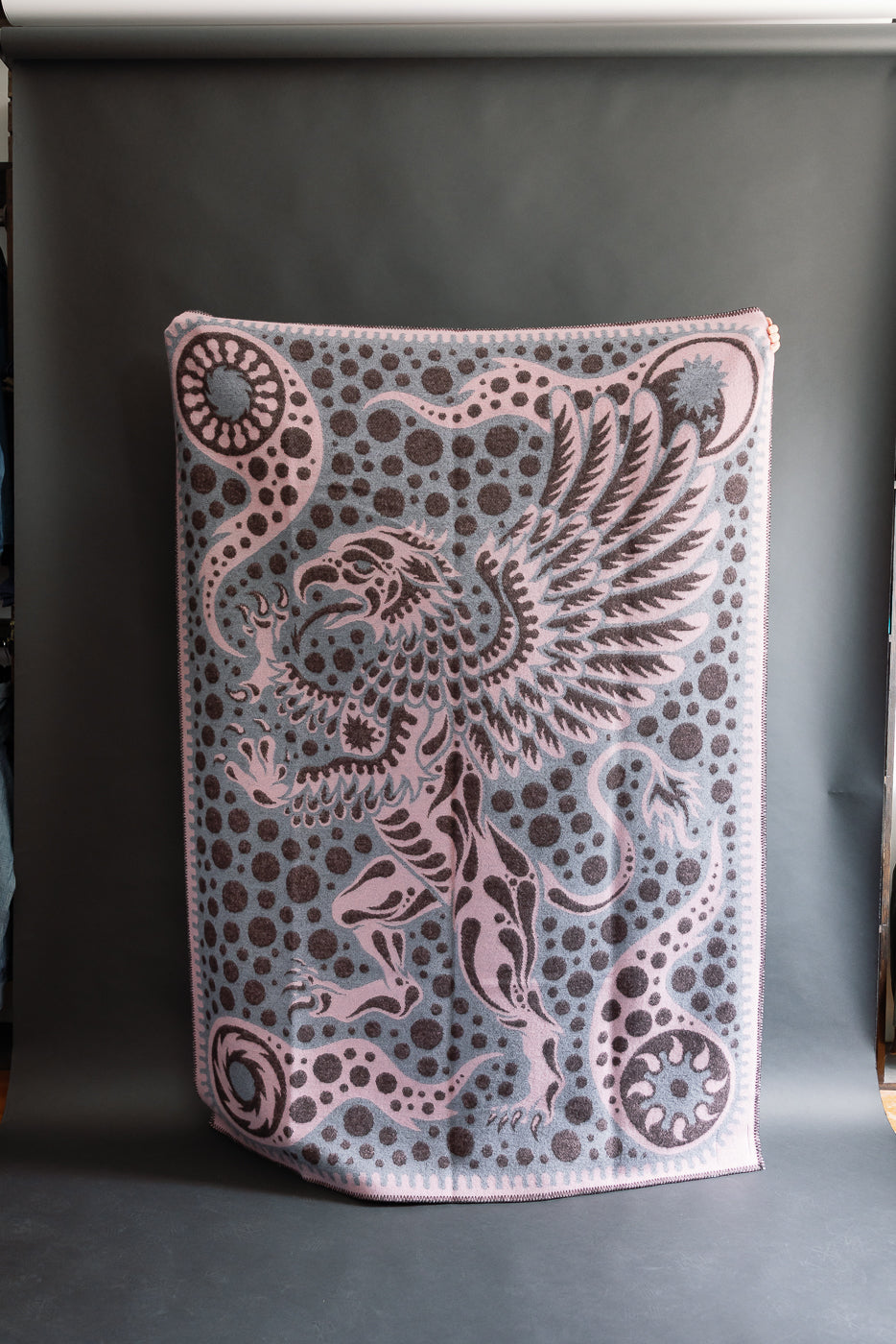 fully open pink blanket with grypon, wings, and bubble pattern, back
