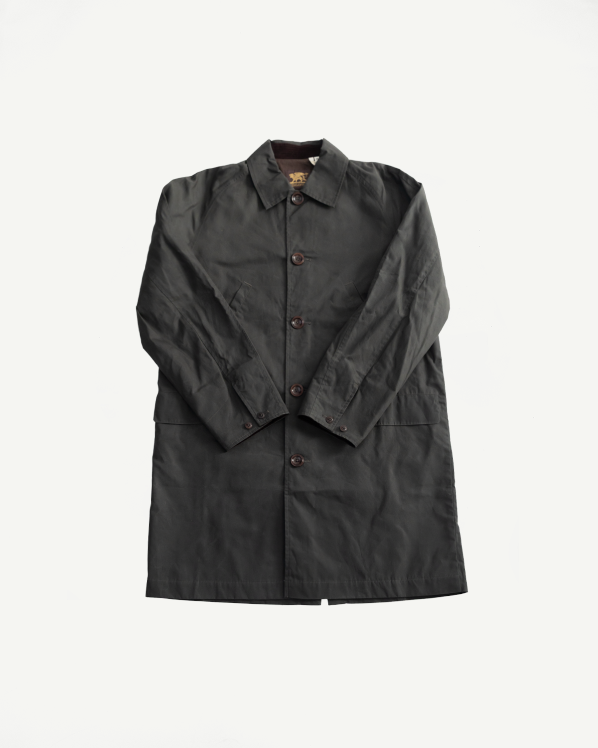 Flat lay front view of Indigofera Raven coat, dark grey coated cotton twill, classic collar, button front, visible texture, Dant contemporary casual apparel