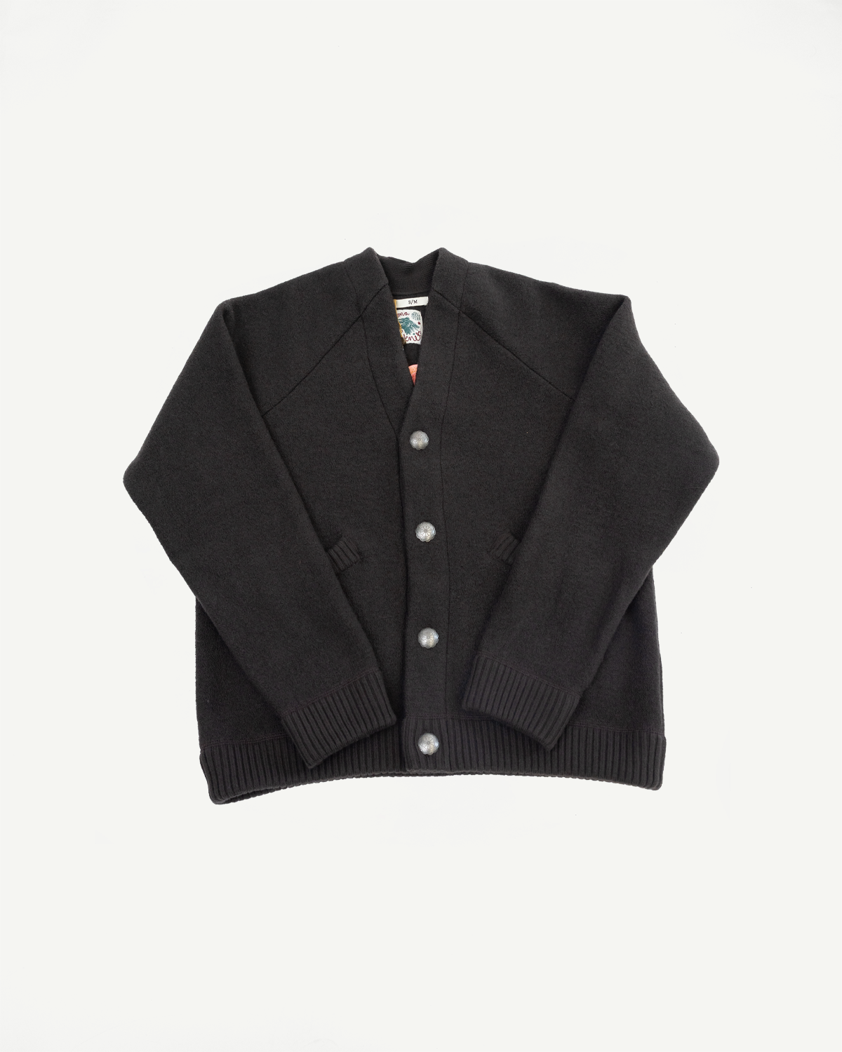 Front view flat lay of a black long-sleeve cardigan with silver buttons and ribbed cuffs.