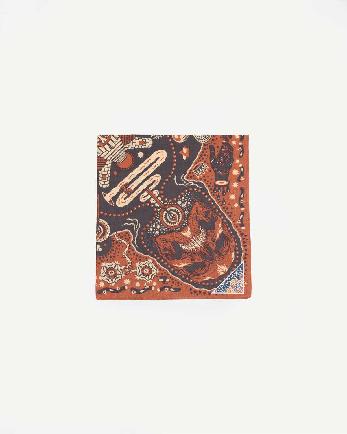 Flat lay front view of patterned bandana with skull, snakes, and geometric designs in orange and navy.