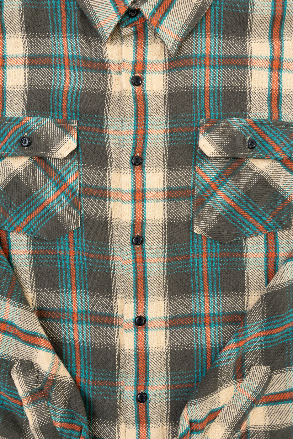 Close-up front view of a plaid flannel shirt showing button placket and chest pockets.