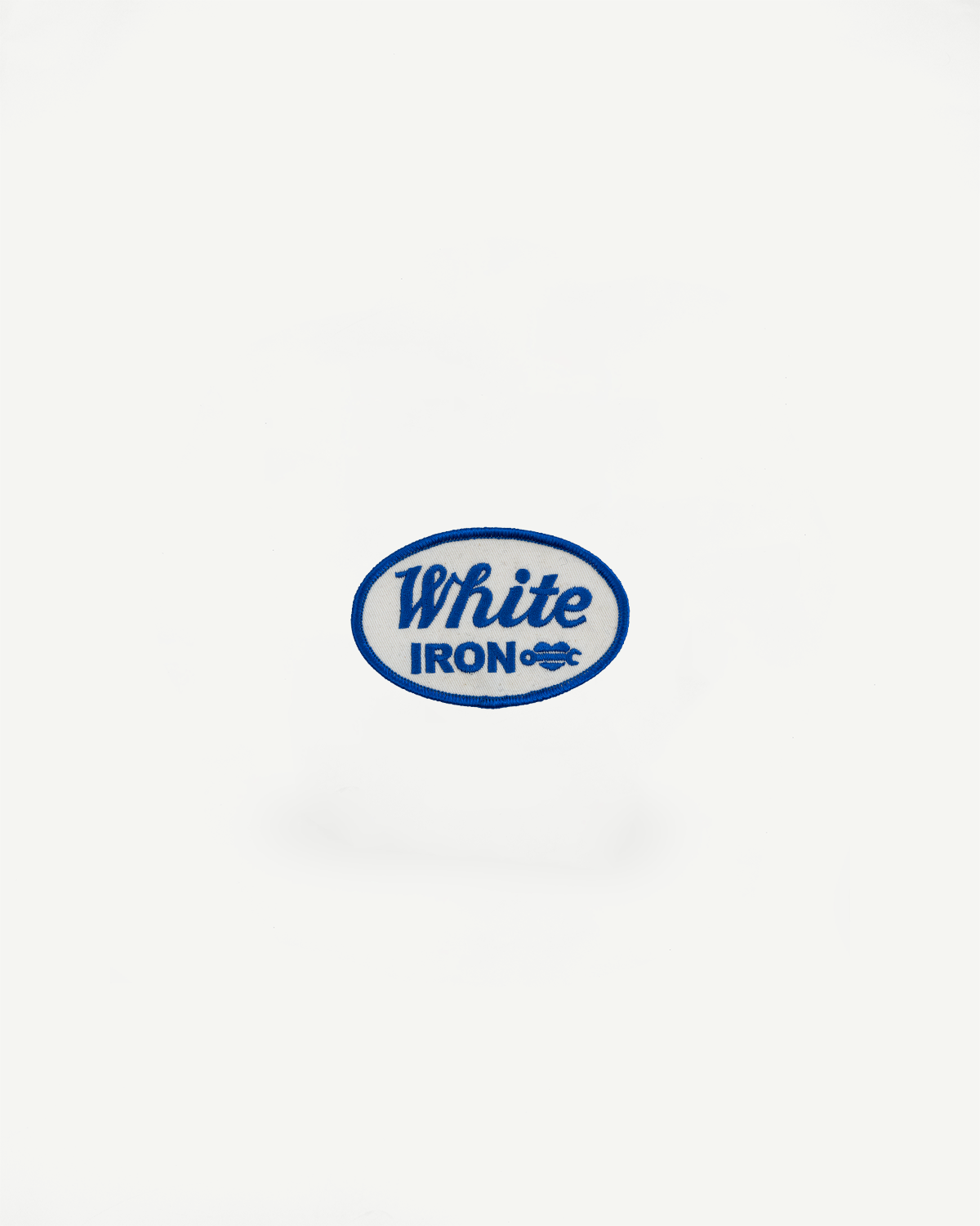 White Iron embroidered patch with blue border, front view, close-up detail