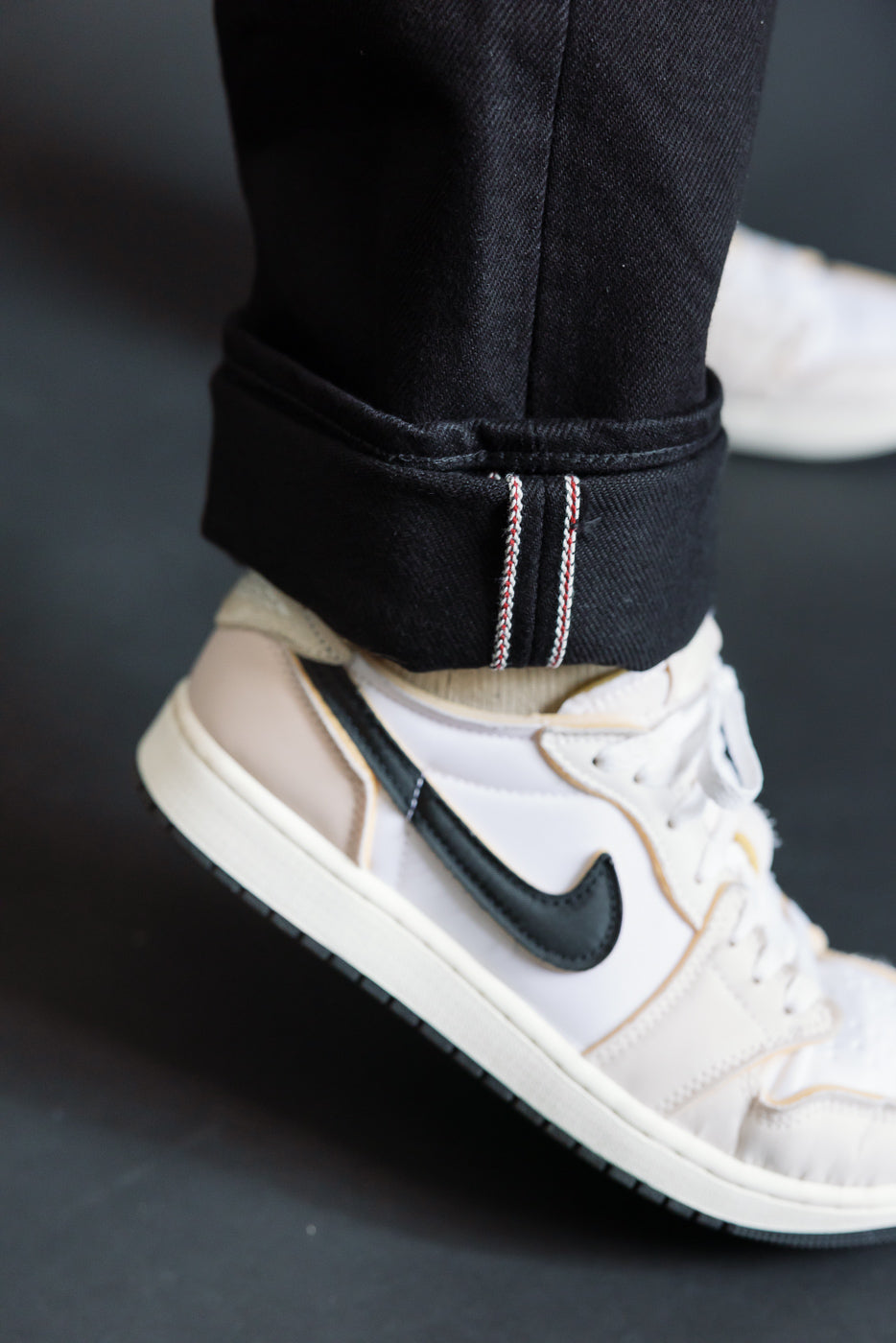 Close-up of cuffed Iron Heart IH-634S superblack selvedge denim jeans hem, right side, on male model 5'9