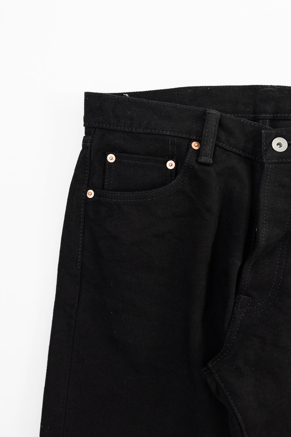 Close-up front left hip and pocket detail of Iron Heart IH-634S SBG 21oz superblack selvedge denim jeans, showing button, rivets, and heavy-duty stitching.