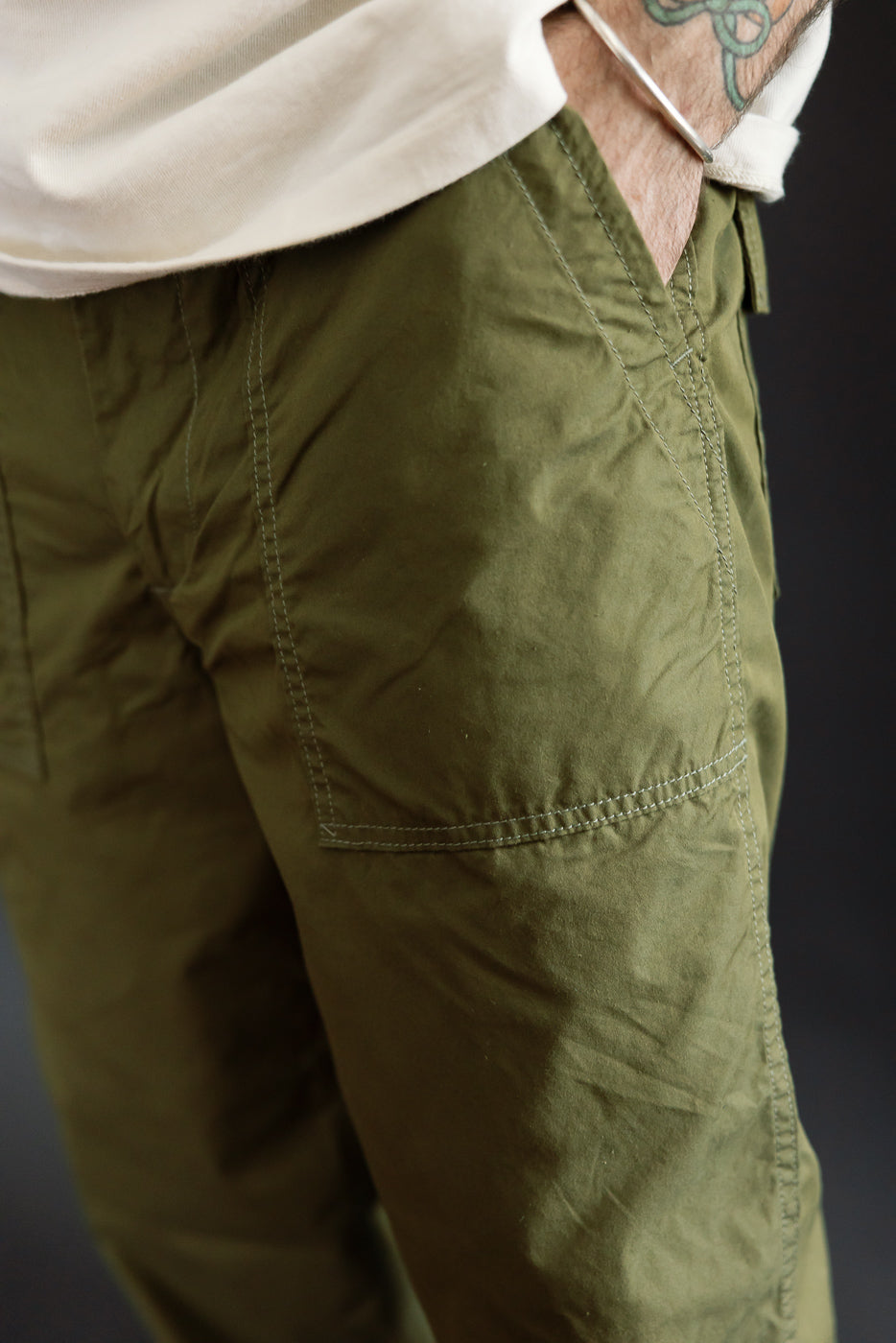 Close-up of olive green cargo pants front, male model 5'9