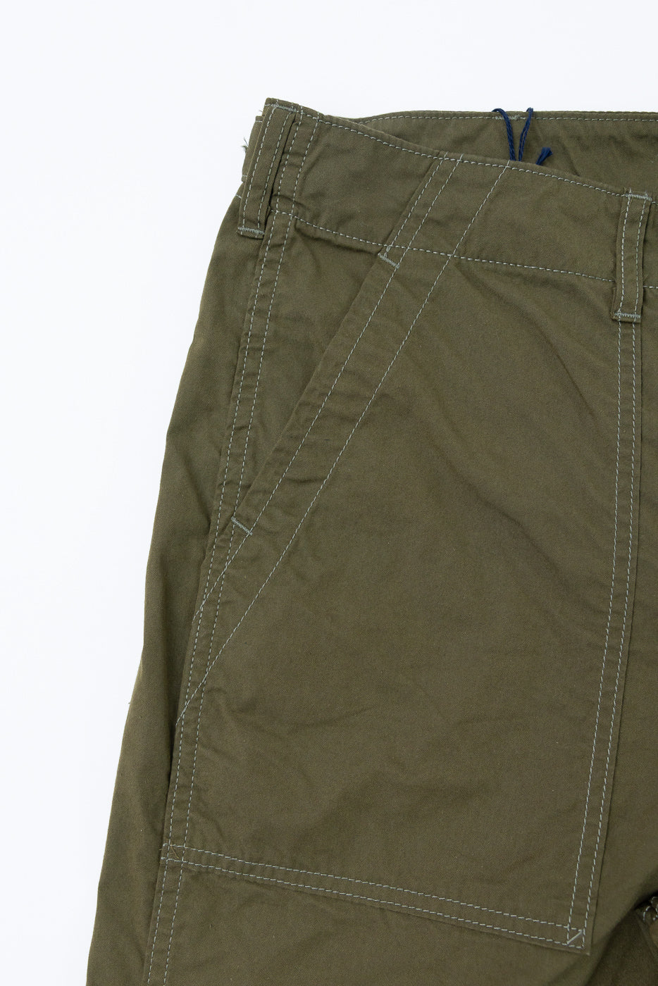Close-up of olive green pants front, showing white stitching, blue drawstring, and pocket detail